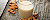 Mandeln und ein Glas mit Mandelmilch auf Holzunterlage - © stock.adobe.com / viperagp / #107324655